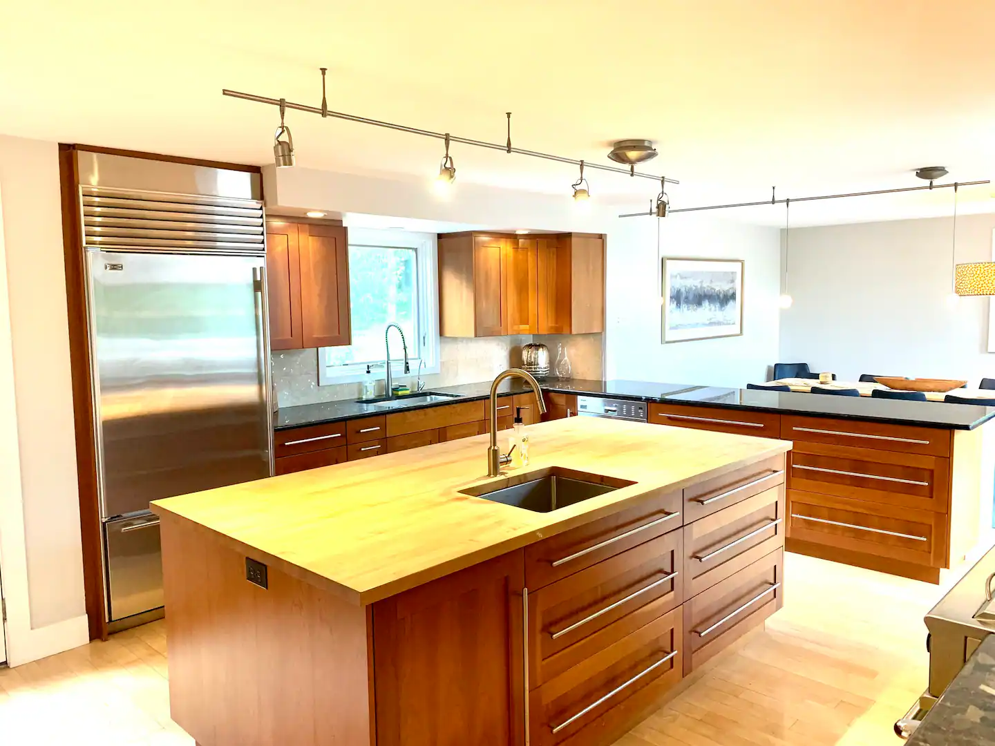 Chef's kitchen with a large wood island